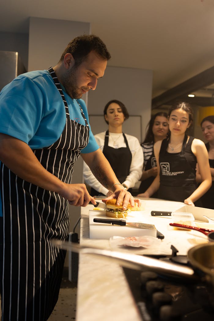 A professional chef in Samsun, Türkiye conducts a cooking workshop, demonstrating burger preparation.