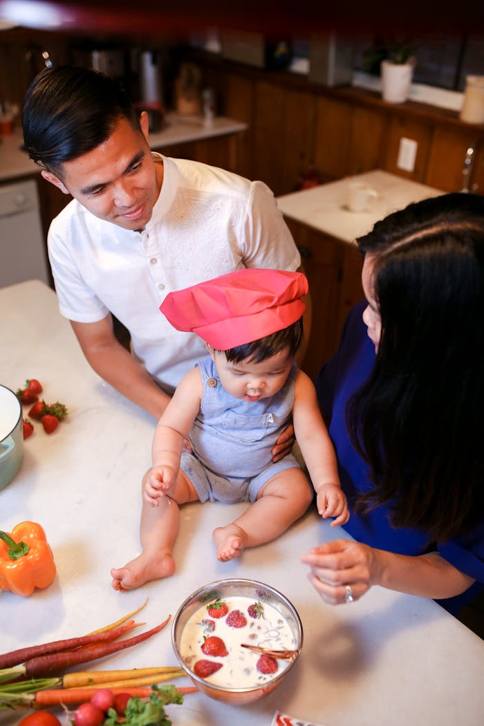 A family of three enjoys cooking together in the kitchen, making healthy food with love and fun.