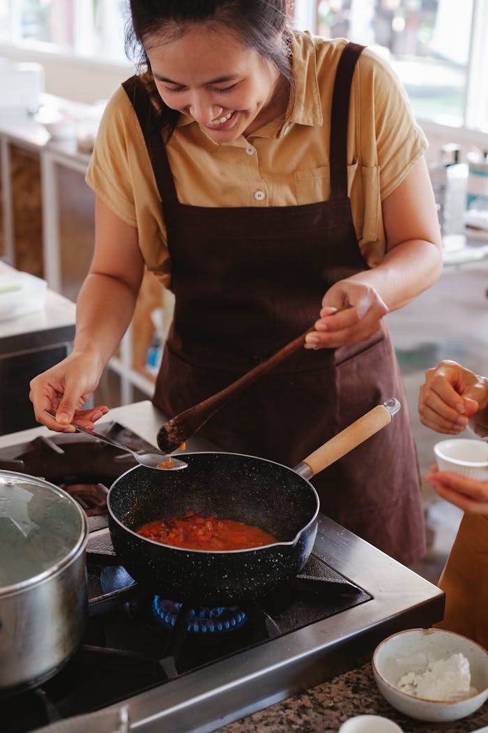 Chef cooking with joy while preparing a delicious meal in a modern kitchen.